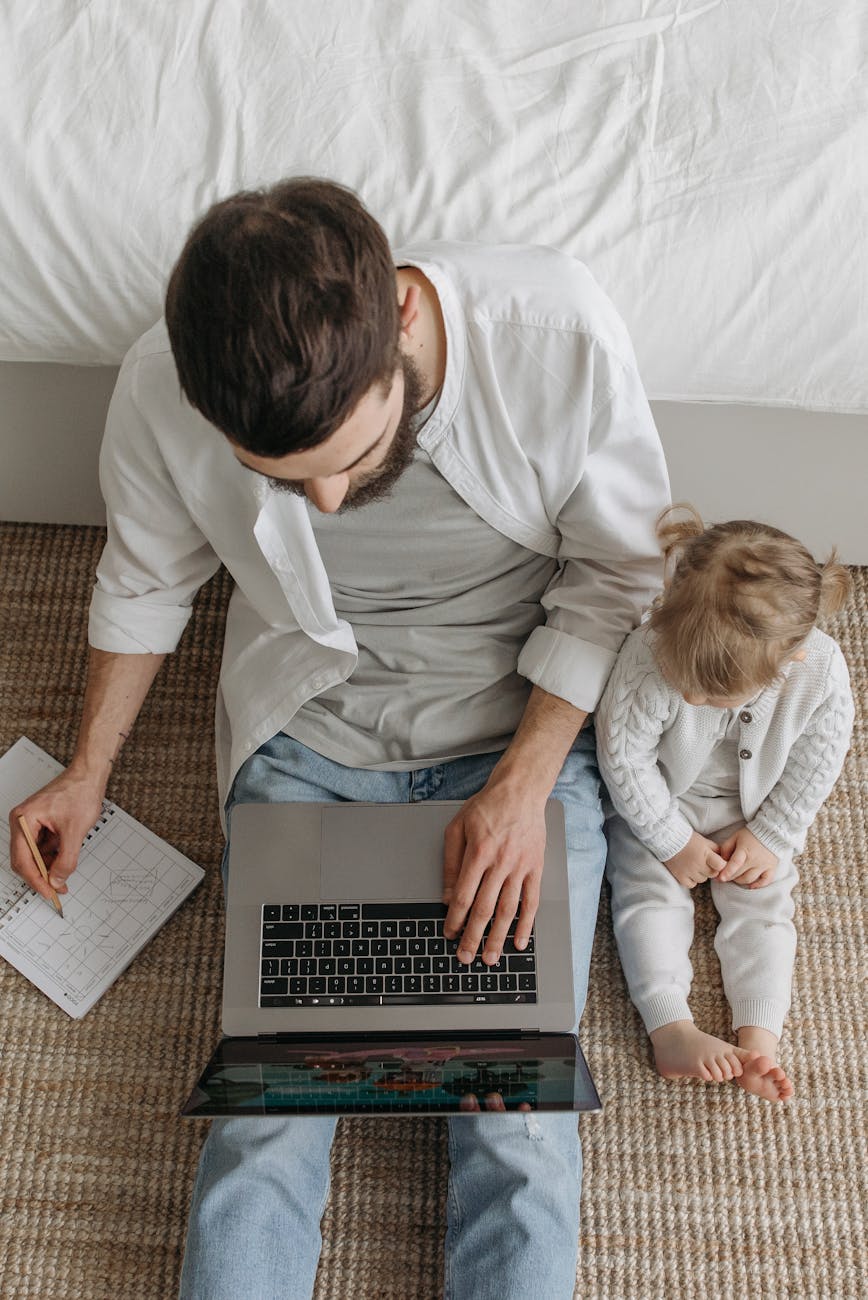 overhead shot of a man working beside his child